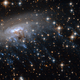 Illustration for article titled Haunting new Hubble image shows a galaxy being ripped to shreds